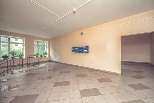 Empty hall mailboxes and elevator doors at new apartment building