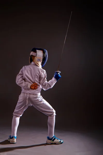 boy engaged in fencing