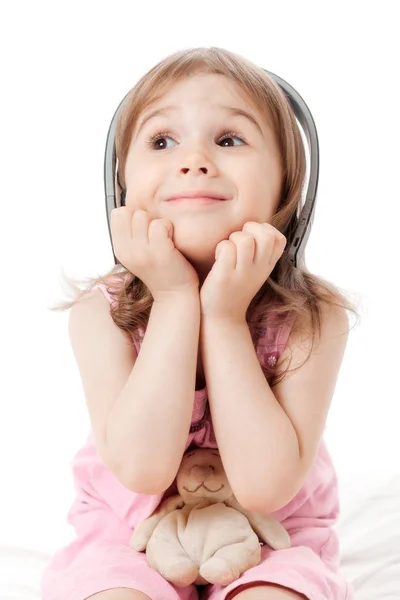 The little girl listens to music — Stock Photo, Image