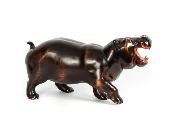 Wooden figure of a hippopotamus isolated on background. — Stock Photo, Image