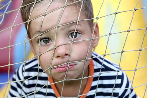 Child face behind net — Stock Photo, Image