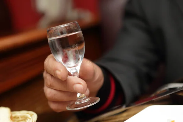 Person holding glass of vodka — Stock Photo, Image