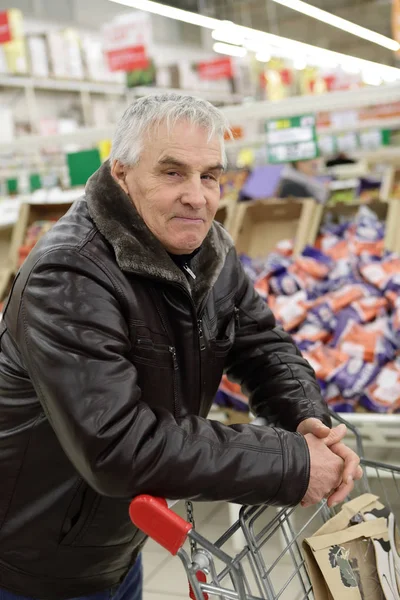 Senior man with shopping cart — Stock Photo, Image