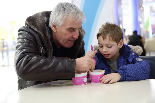 Grandfather and grandson have ice cream — Stock Photo, Image