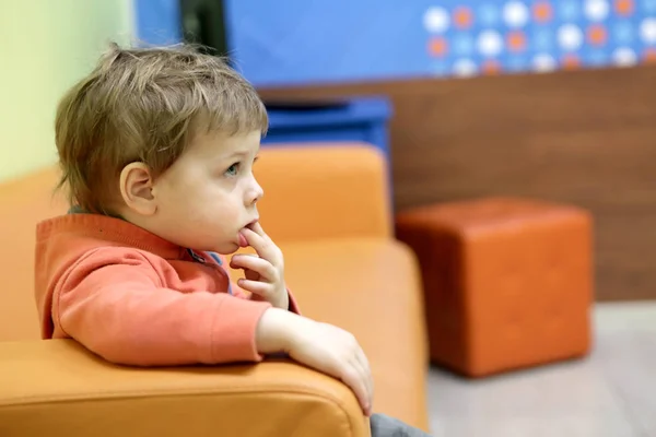 Boy sitting on sofa — Stock Photo, Image