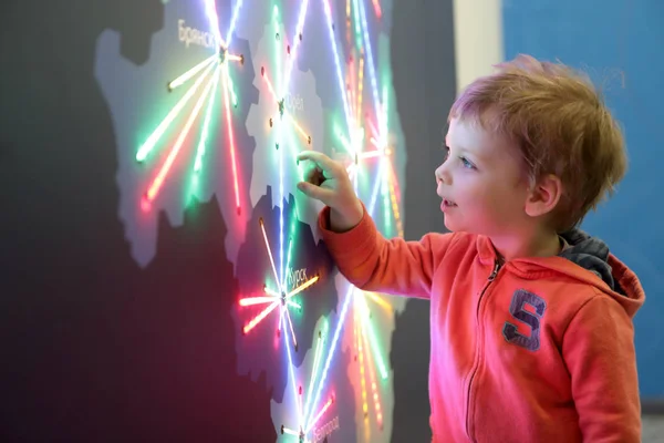 Boy touching glowing map — Stock Photo, Image