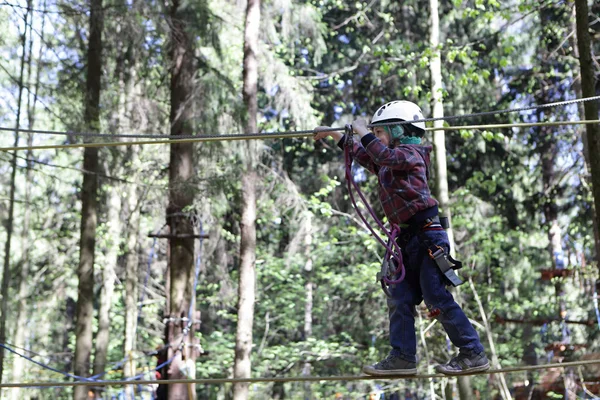 Boy climbing in adventure rope park — Stock Photo, Image