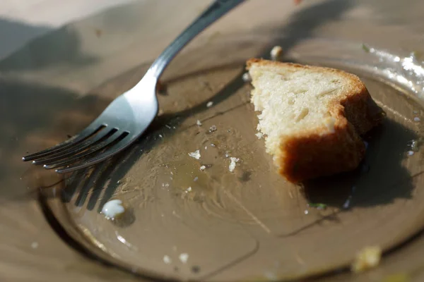 Remains of bread on plate — Stock Photo, Image