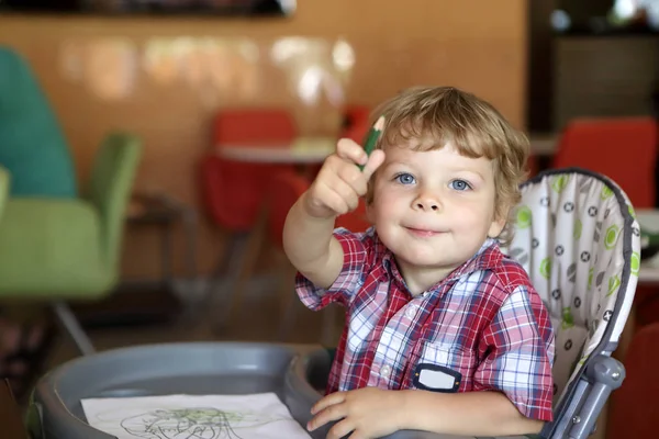 Kid tekening in café — Stockfoto