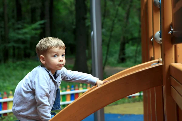 Child climbing on slide — Stock Photo, Image