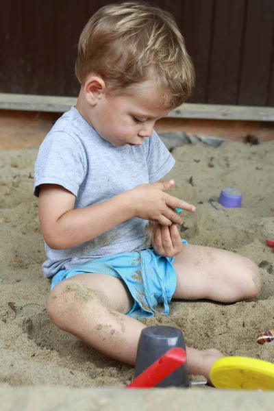 Boy in sandbox — Stock Photo, Image