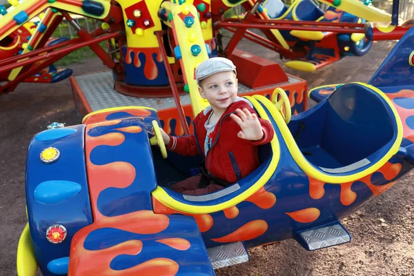 Kid in plane on carousel — Stock Photo, Image