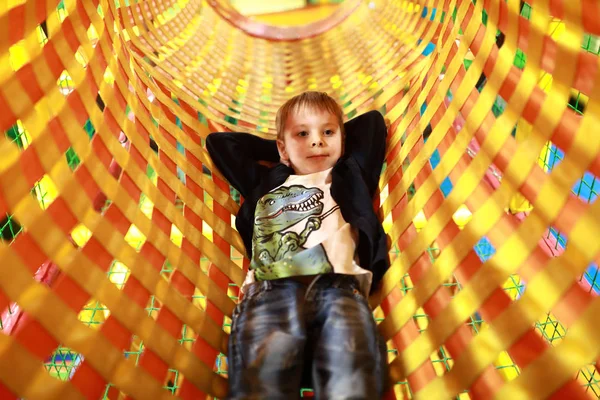 Child lying in tube — Stock Photo, Image