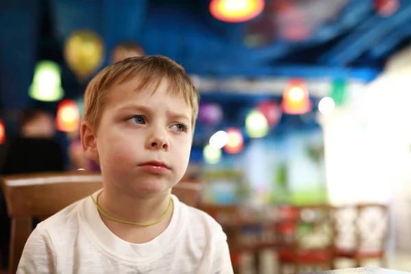 Pensive child in restaurant — Zdjęcie stockowe