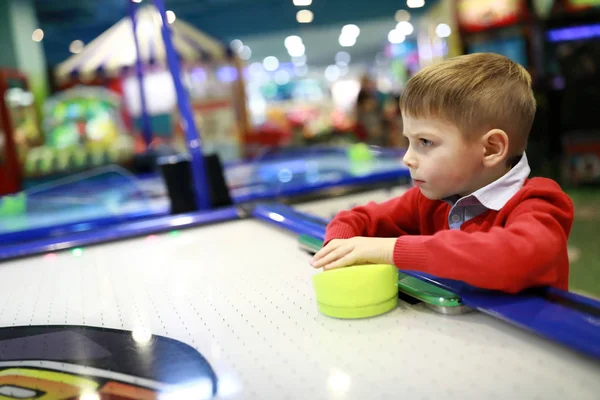 Boy playing air hockey