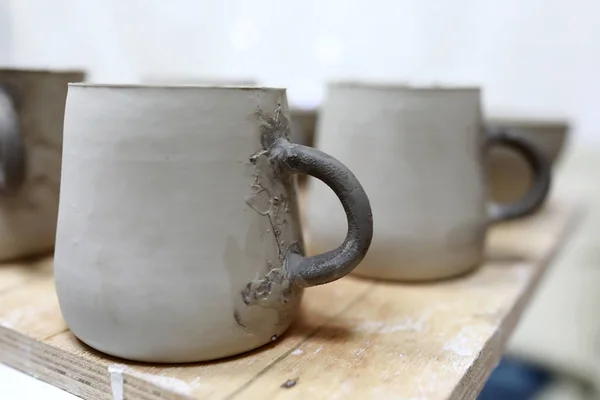 Clay mugs on table — Stock Photo, Image