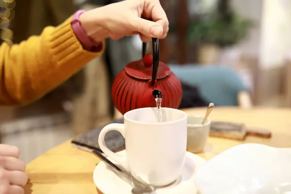 Person pouring herbal tea — Stock Photo, Image