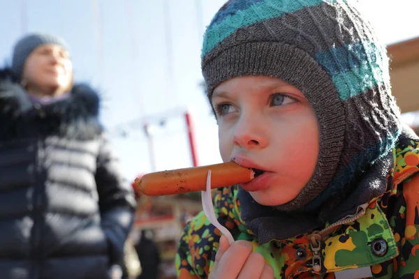 モスクワ ロシアの通りでソーセージを食べる子供 — ストック写真