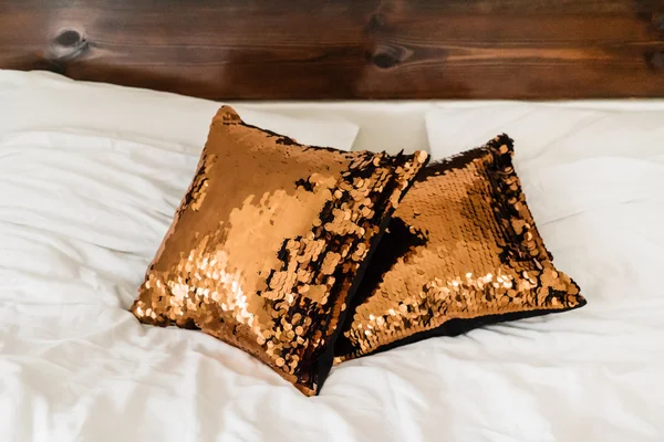 Sequin pillows on bed — Stock Photo, Image