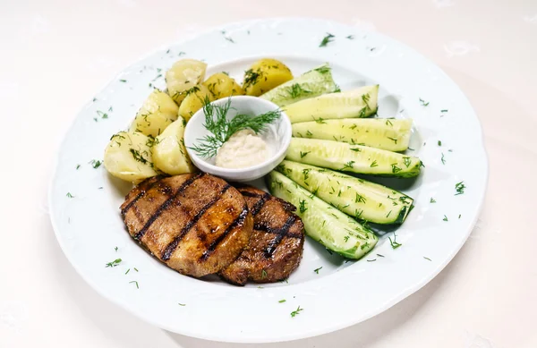 meat with potatoes and cucumber