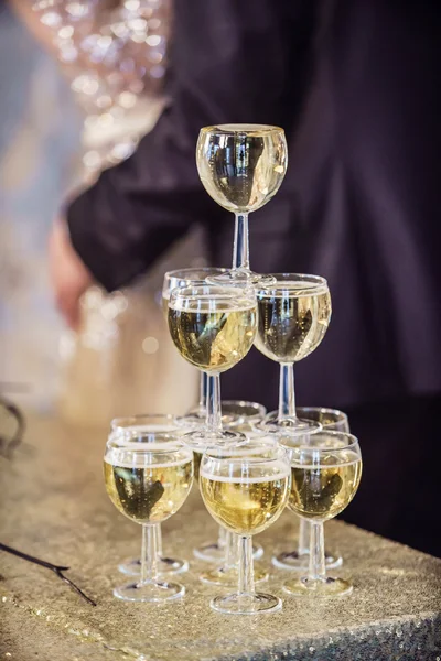 Couple by champagne glasses tower