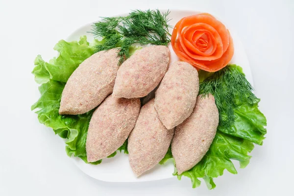 Raw cutlets with salad — Stock Photo, Image