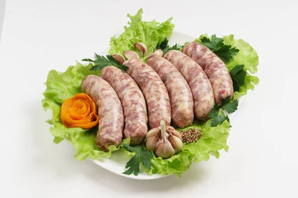 Raw sausages with salad — Stock Photo, Image