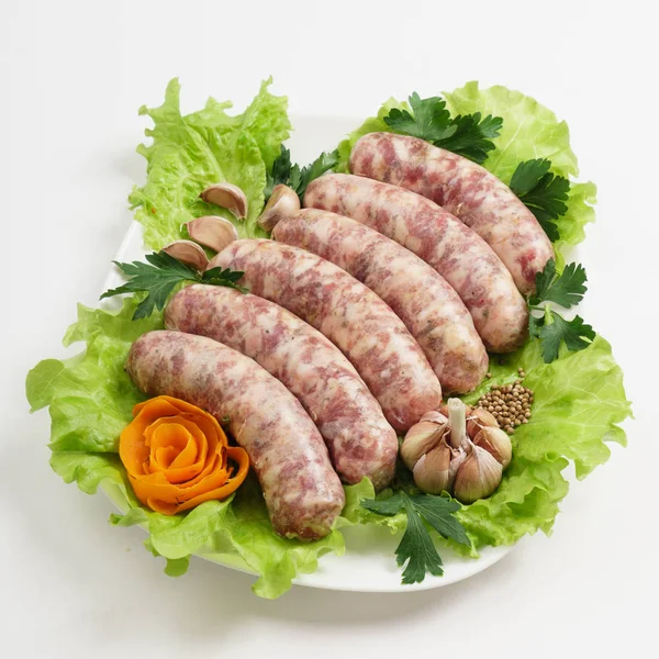 Raw sausages with salad — Stock Photo, Image