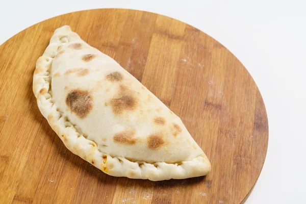 Calzone pizza on board — Stock Photo, Image