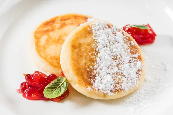 Cheese pancakes with cherry jam — Stock Photo, Image