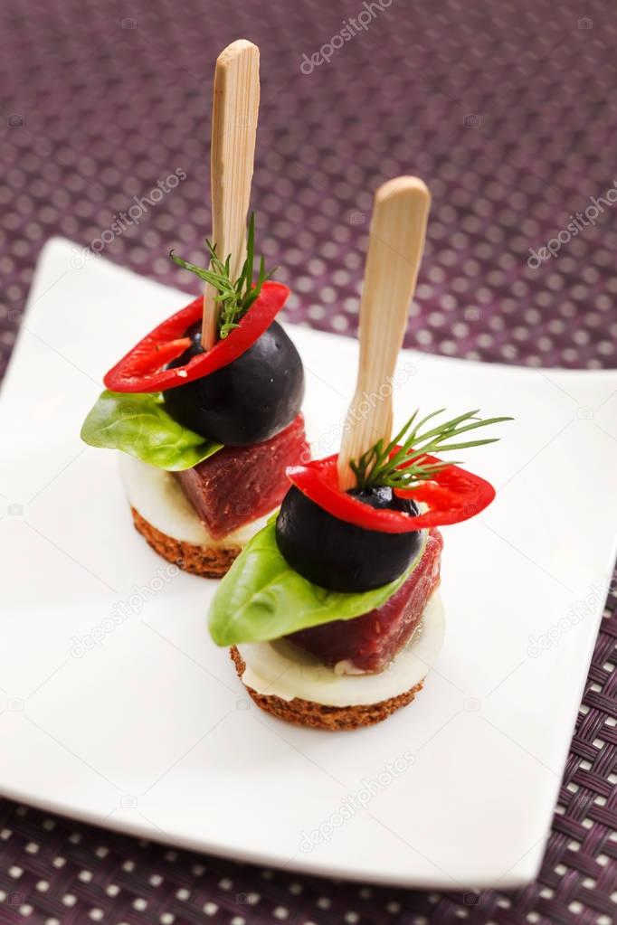 delicious canapes on plate 