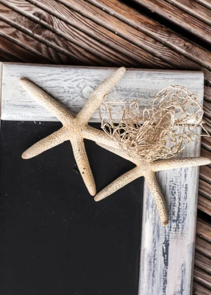 Empty blackboard with starfishes — Stock Photo, Image