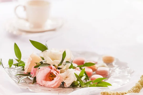 present with macarons and flowers