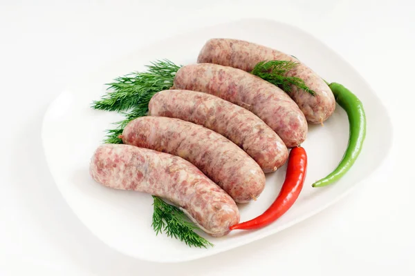 Raw sausages with peppers — Stock Photo, Image