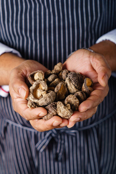 chef holding shiitake in hands