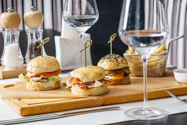 Tasty burgers with french fries — Stock Photo, Image