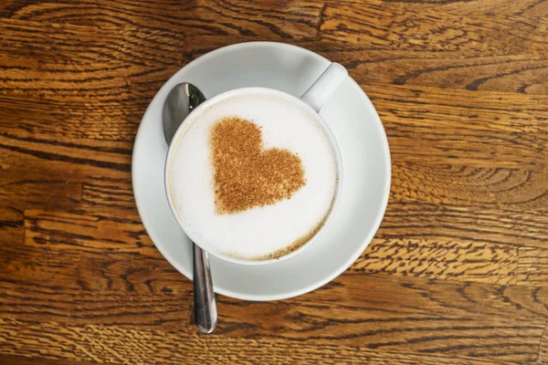 Latte in coffee cup with heart — Stock Photo, Image