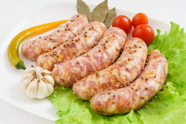 Raw sausages with tomatoes — Stock Photo, Image