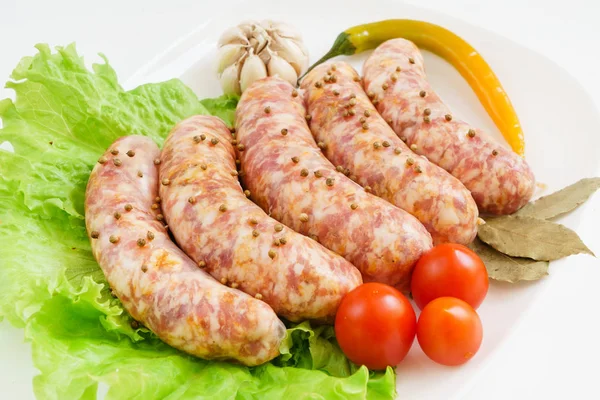 Raw sausages with tomatoes — Stock Photo, Image