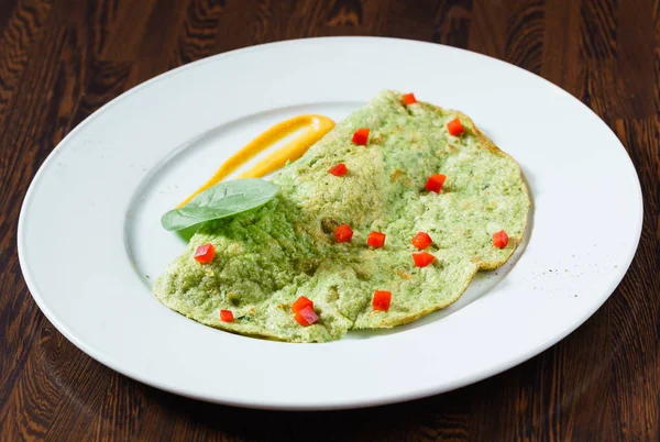 Spinach omelette on white plate — Stock Photo, Image