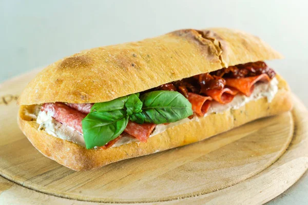 Sandwich with sausages and dried tomato — Stock Photo, Image