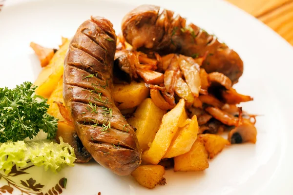 Sausages and sauteed potatoes — Stock Photo, Image