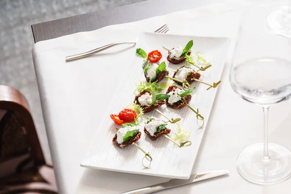 Dried tomatoes and cream cheese canapes — Stock Photo, Image