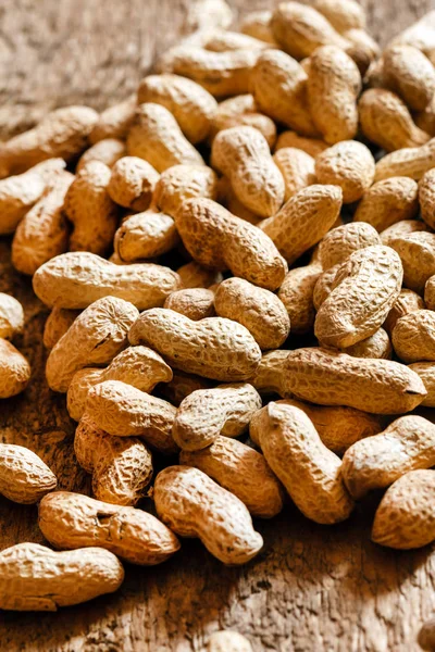 Pile of peanuts on wood — Stock Photo, Image