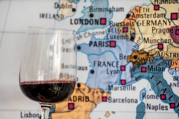 glass of wine near map. Travel