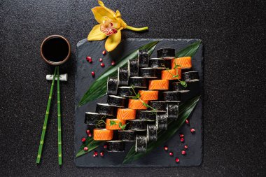 Siyah arka planda lezzetli suşi, yakın plan.