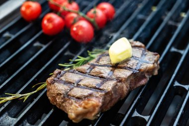 grilled steak with cherry tomatoes and rosemary