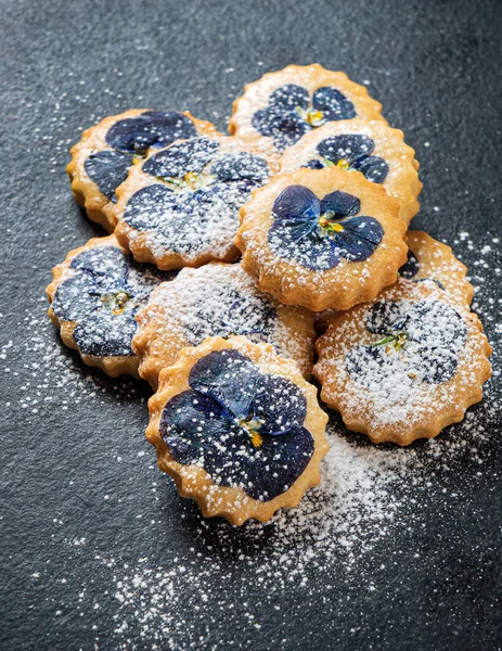 PANSY TOPPED SHORTBREAD COOKIES ON BLACK BACKGROUN