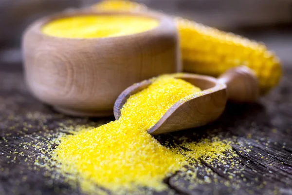 Yellow Corn meal on wooden table — Stock Photo, Image