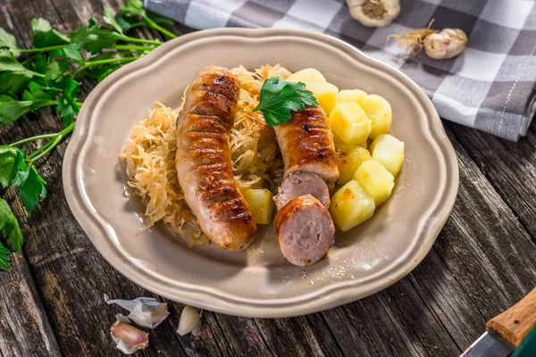 Grilled sausages with potatoes — Stock Photo, Image